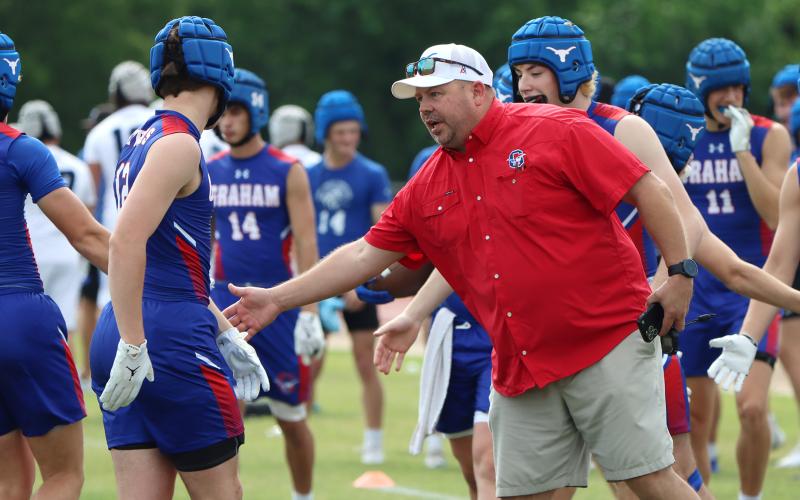 (THOMAS WALLNER | THE GRAHAM LEADER) Steers 7on7 coach ZT Burkett congratulates the team after their win during the Mineral Wells SQT. 