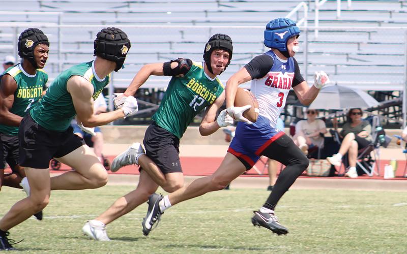 (ALEX HAVARDANSKY | THE GRAHAM LEADER) Parker Hale runs away from defenders to the endzone for a touchdown Saturday, May 24 against Benbrook in a 7on7 tournament. Hale erupted in the second half of that matchup with two scores on back to back drives. 