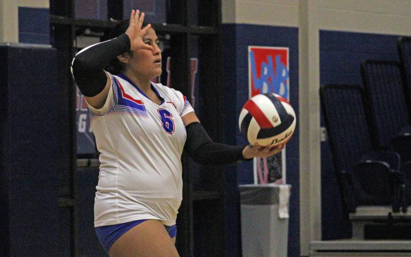 (ALEX HAVARDANKSY | THE GRAHAM LEADER) Alexis Aguirre prepares to throw the ball up for a serve Tuesday, Oct. 21 against the Brock Lady Eagles. The Lady Blues lost their final home matchup to Brock in two sets. 