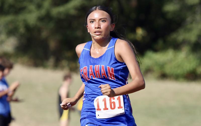 (KYLIE BAILEY | THE GRAHAM LEADER) Angela Fuentes makes her way around the course during one of the Lady Blues cross country meets. Fuentes finished 36 at the District 6-4A championships Monday, Oct. 6, at Brock High School. 