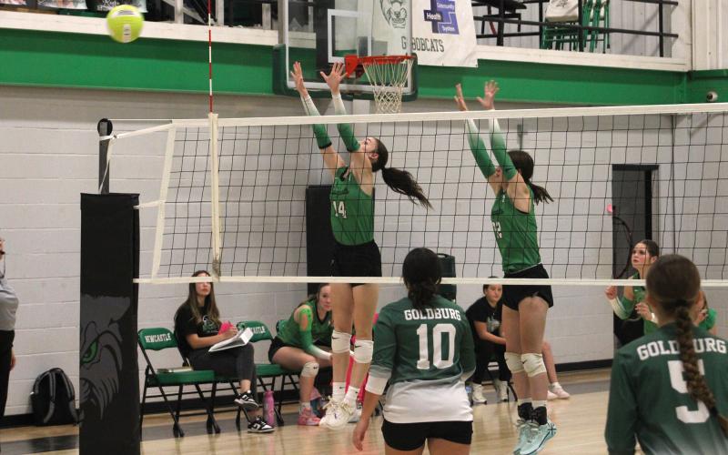 (ALEX HAVARDANSKY | THE GRAHAM LEADER) Aubree Clayton, left, and Kinzee Forbus, right, go up for a block Tuesday, Sept. 16, against the Gold-Burg Lady Bears. Both Clayton and Forbus shined in the Ladycats dominant three-set win. 