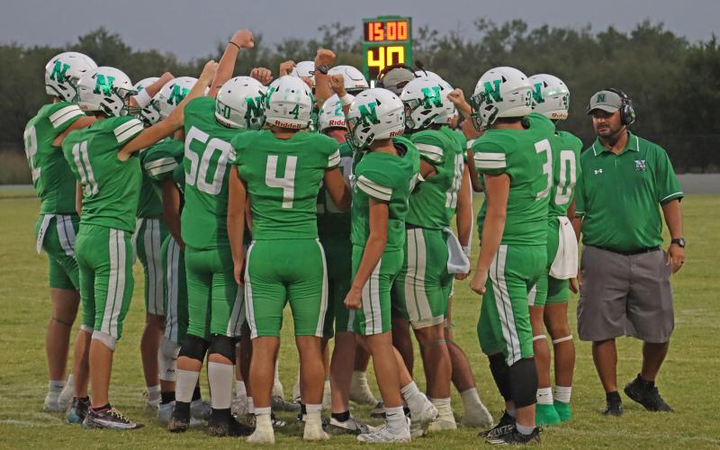 (THOMAS WALLNER | THE GRAHAM LEADER) The Newcastle Bobcats huddle with their coaching staff on the sideline. The Bobcats maintained their undefeated 3-0 record after defeating the Gold-Burg Bears. 