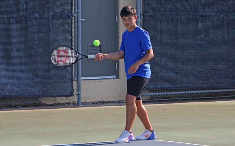 (ALEX HAVARDANSKY | THE GRAHAM LEADER) Brodey Mills swings at a ball during a singles match. Mills picked up a singles win against Glen Rose during their meet Thursday, Aug. 21.