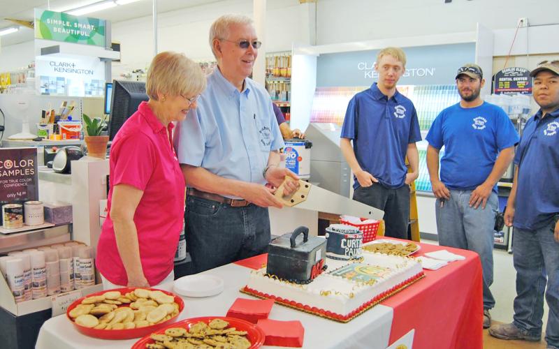 (GRAHAM CHAMBER OF COMMERCE | CONTRIBUTED PHOTO) Curtis and Geneva Buchanan cut a cake May 8, 2014 to celebrate 40 years of their business in Graham. The event was held with a ribbon cutting ceremony from the Graham Chamber of Commerce.