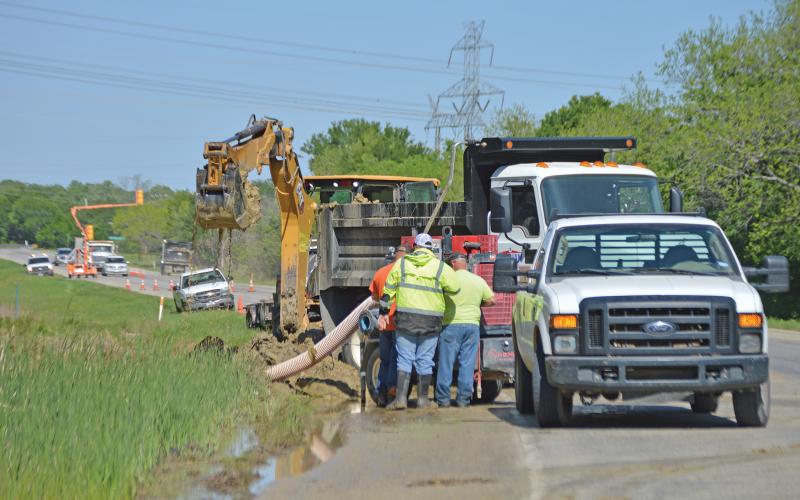 (ARCHIVE PHOTO | THE GRAHAM LEADER) City of Graham crews work to repair the main water line on Hwy. 61 which had ruptured April 15, 2023. The Graham City Council held a public hearing Thursday, July 31 regarding increases to the water and sewer rates as a way to potentially help with infrastructure projects.