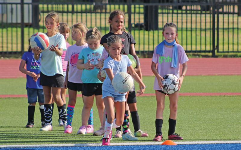 (ARCHIVE PHOTO | THE GRAHAM LEADER) Lady Blues younger soccer campers participating in a longest kick competition in July 2025. Soccer camps will be held July 21-23 and July 22-23 for different age groups.