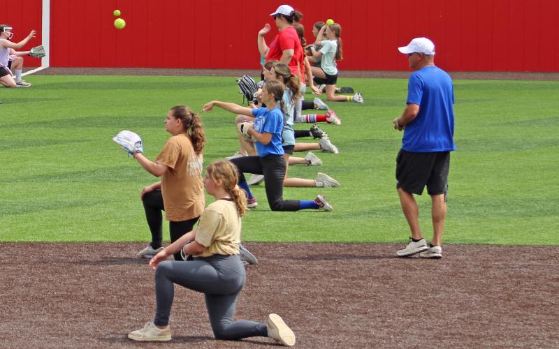 (ARCHIVE PHOTO | THE GRAHAM LEADER) The Lady Blues practice throwing mechanics at softball camp in 2025. The camp will take off next week from May 26-28 at Hogan Field.