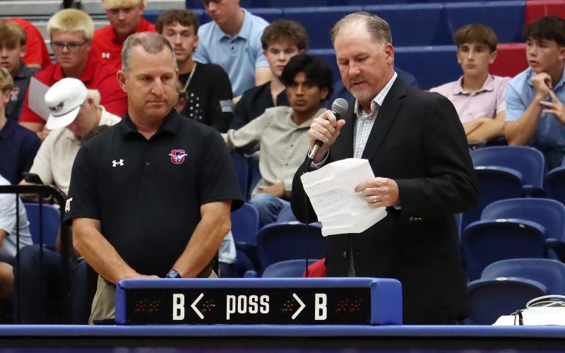 (THOMAS WALLNER | THE GRAHAM LEADER) Mike Carroll (left) is recognized by Graham ISD Athletic Director Clay McChristian during the All Sports Banquet held at the Graham High School gym Tuesday, May 12. 