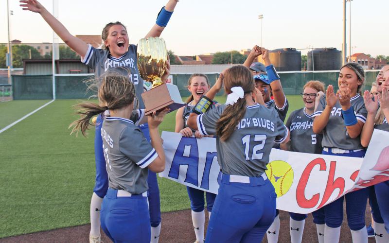 ARCHIVE PHOTO | THE GRAHAM LEADER The Graham Lady Blues softball team celebrates the program’s first area championship since 2018. The championship was won Monday, May 8 at Midwestern State University after defeating Sanger in a best-of-three series.
