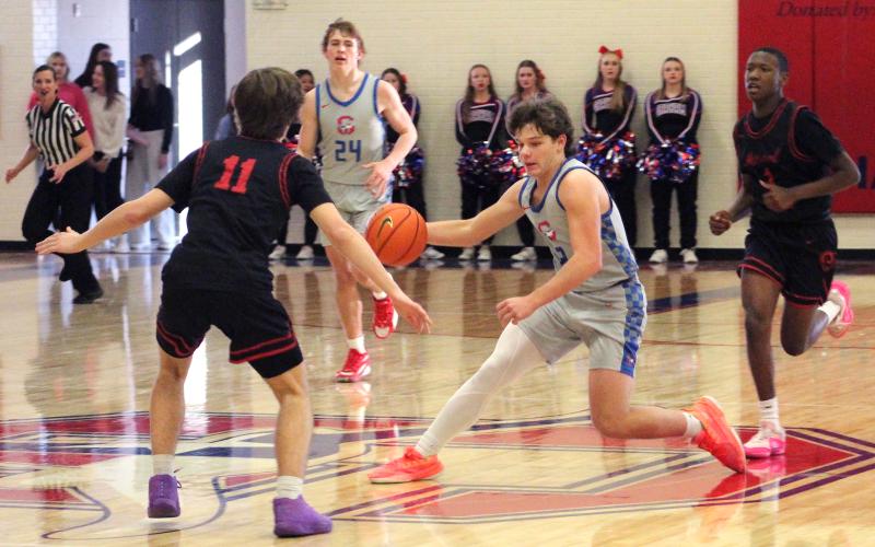 (TC GORDON | THE GRAHAM LEADER) Cooper Corley crosses over a Mineral Wells defender at midcourt as he breaks away for fast Graham points. The JV Red Steers beat the Rams 61-46 last Friday, Jan. 19.