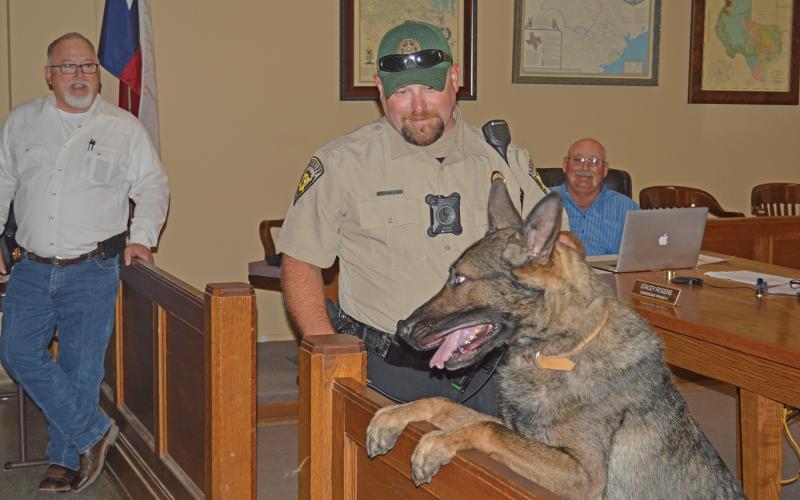 (ARCHIVE PHOTO | THE GRAHAM LEADER) K-9 Handler Devin Wright and his K-9 partner Rocky are introduced to the Young County Commissioners Court in March 2018. Rocky died Tuesday, Sept. 2 and was given a police escort from a vet in Olney to Strawn.