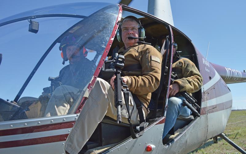 (ARCHIVE PHOTO | THE GRAHAM LEADER) Shooters prepare to take off in a helicopter in March 2023 as part of the training with the Helicopter Hog Hunt. The event serves as a fundraiser for Young County Warrior Ranch and its efforts to provide for veterans.