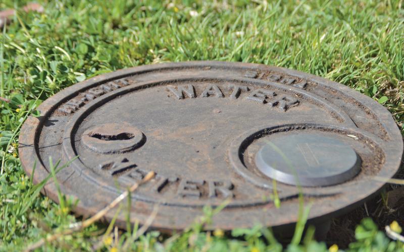 (ARCHIVE PHOTO | THE GRAHAM LEADER) A water meter lies buried in Graham on Second Street. During certain drought stages, the city may ask or require residents to restrict water usage.