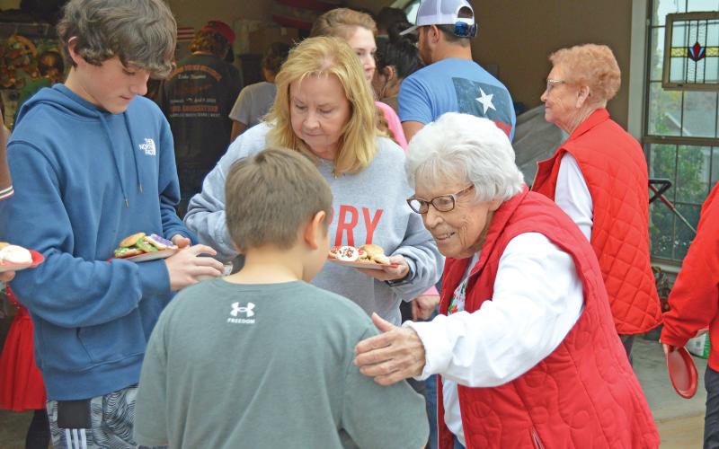 (ARCHIVE PHOTO | THE GRAHAM LEADER) Mary Braddock speaks with visitors to Cookie Day at her home in 2022. The annual event has been a family tradition for over 60 years and continues next week from 4-6 p.m. Friday, Dec. 8. 