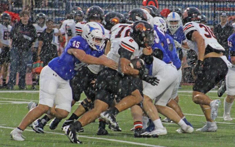 (ALEX HAVARDANKSY | THE GRAHAM LEADER) Denton Lauster makes a tackle in the backfield Friday, Sept. 5. Lauster is a senior defensive end on the team. 
