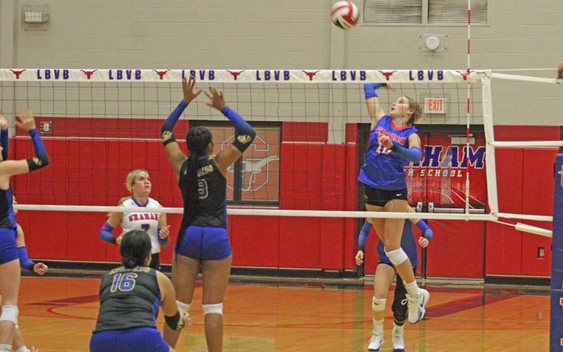 (ALEX HAVARDANKSY | THE GRAHAM LEADER) Emily Hughes swats at a ball for a kill Friday, Sept. 12. Hughes was one of the most pivotal offensive players in the Lady Blues three set win over the Lady Leopards.