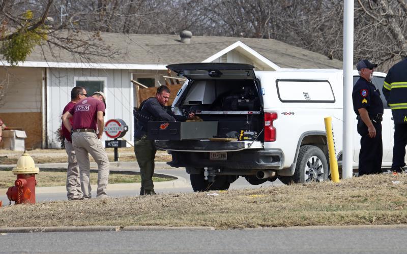 (THOMAS WALLNER | THE GRAHAM LEADER) A member of the Denton Fire Department bomb disposal team on scene, along with other first responders, at the Gateway Inn.