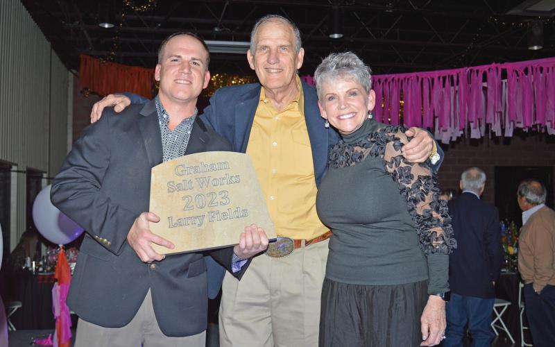 (ARCHIVE PHOTO | THE GRAHAM LEADER)Larry Fields (center) accepts the Graham Salt Works award from Graham Chamber of Commerce Board President Chance Condron (left) and Chamber CEO Cathy Partridge during the Chamber banquet in February 2023. 