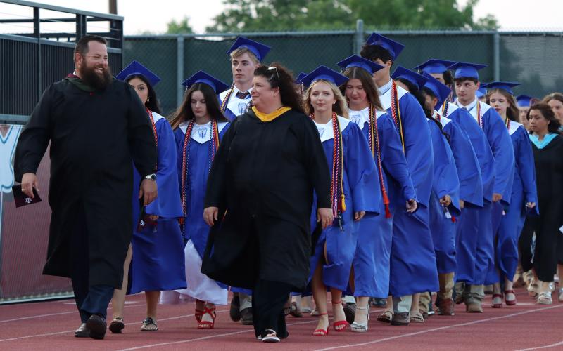 (THOMAS WALLNER | THE GRAHAM LEADER) Graham High School Principal Adam Anderson and Assistant Principal Necia Marin lead the Class of 2026 graduates onto Newton Field for the start of the graduation ceremony held Friday, May 22.