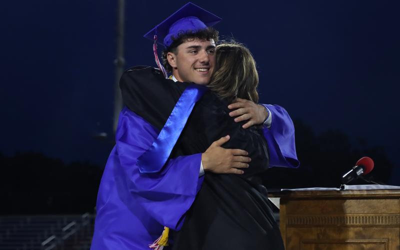 (THOMAS WALLNER | THE GRAHAM LEADER) Graham High School graduate Tripp Mahaney hugs his mother Lauren, who serves on the Graham ISD Board of Trustees, during the graduation ceremony held Friday, May 22. 