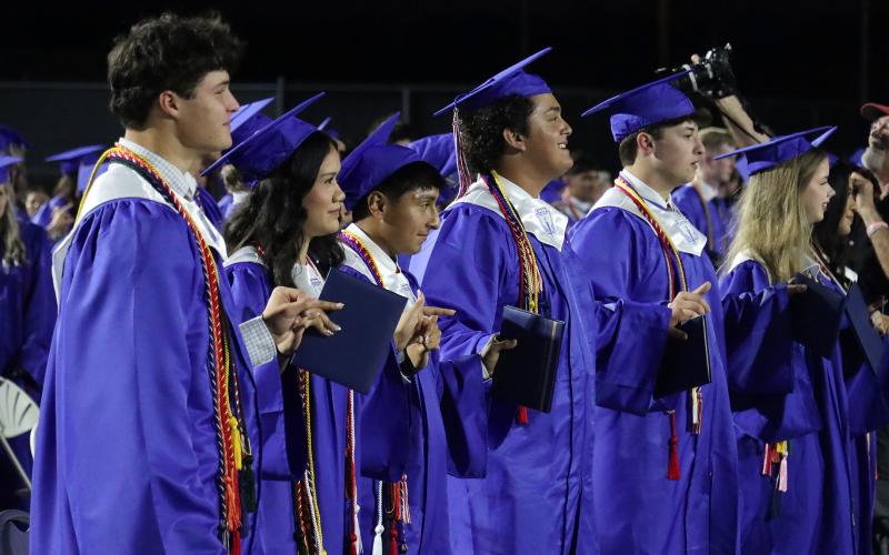 (THOMAS WALLNER | THE GRAHAM LEADER) Graham High School graduates lock hands as they sing the school song at the conclusion of the graduation ceremony held Friday, May 22. 