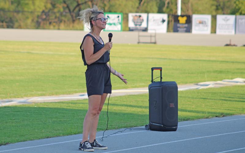 (ALEX HAVARDANSKY | THE GRAHAM LEADER) Tina Hawkins gives opening remarks at the Meet the Bobcats and Ladycats Booster Bash event Thursday, Aug. 7. Hawkins serves as the booster club president in Newcastle.