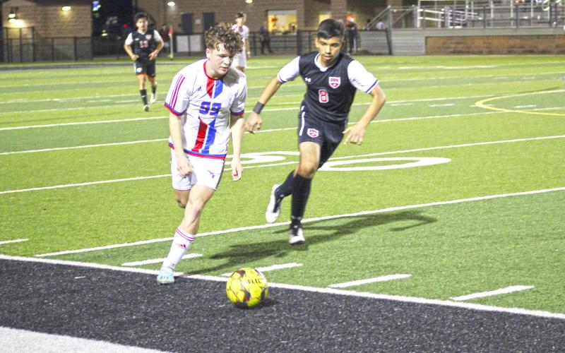 (MIKE WILLIAMS | THE GRAHAM LEADER) Easton Hedge defeats a defender during the first half of the Steers' 2-1 loss at Mineral Wells Monday night.