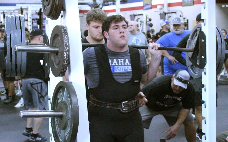 (TC GORDON | THE GRAHAM LEADER) Reese McCrae of the Steers powerlifting team sets himself up to perform his squat lift during a competition held in Graham last Thursday, Feb. 1.
