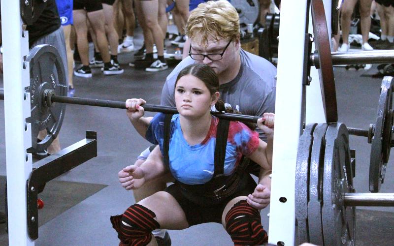 (TC GORDON | THE GRAHAM LEADER) Hope Jones of the Lady Blues powerlifting team reaches the bottom of her squat lift during a competition held in Graham Thursday, Feb. 1.