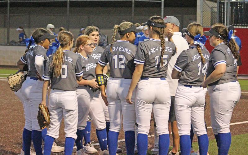 (TC GORDON | THE GRAHAM LEADER) Head coach Adam Arrington talks to his team in between innings during one of Graham’s recent games. The Lady Blues took on the Bridgeport Sissies and routed them 17-0 in a matchup Tuesday, March 5.