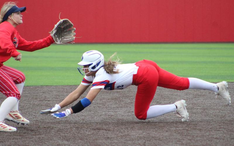 (TC GORDON | THE GRAHAM LEADER) Senior Olga Morales dives headfirst into second base in an attempted steal during one of Graham’s games in a tournament they hosted over the weekend. The Lady Blues played four games and went 4-0.