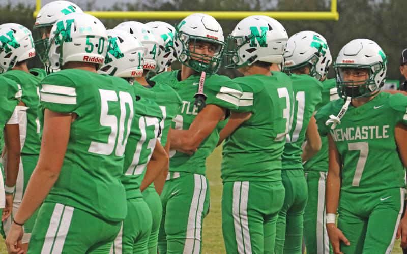 (THOMAS WALLNER | THE GRAHAM LEADER) The Newcastle Bobcats talk strategy on the sideline during one of their matchups. The Bobcats defeated the Northside Indians 46-8 in their latest district matchup Thursday, Oct. 23.