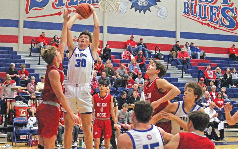 (TC GORDON | THE GRAHAM LEADER) Graham junior Cash Bowen (30) elevates for a close shot over a Glen Rose defender Friday, Feb. 2 during the Steers’ 55-52 loss to the Tigers.