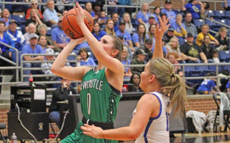 (TC GORDON | THE GRAHAM LEADER) Freshman Kenzie King (0) shoots a floater in the lane during Newcastle’s semifinal win over Huckabay in the regional tournament. The Ladycats faced Dodd City in the finals and won to advance to the state tournament in San Antonio.