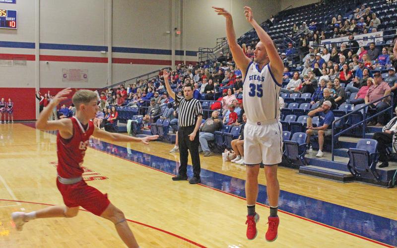 (TC GORDON | THE GRAHAM LEADER) Graham senior Samuel Rodgers (35) shoots a 3-pointer from the corner while a Glen Rose defender closes in during the Steers’ 55-52 loss Friday, Feb. 2 to the Tigers.