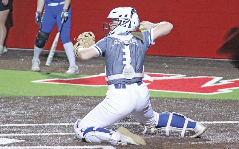 (TC GORDON | THE GRAHAM LEADER) Catcher Meagan Brooks fires a throw to second base in the final warmup between innings during one of Graham’s recent games. The Lady Blues defeated Bridgeport 17-0 in a game Tuesday, March 5.