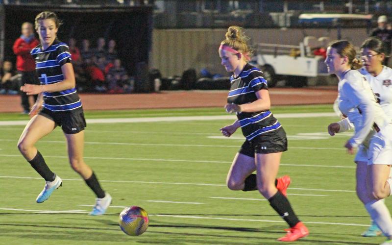 (TC GORDON | THE GRAHAM LEADER) Olivia Pettus (14) sets up to fire a shot at goal, which she scored to give the Lady Blues a 1-0 lead early on in the match Wednesday, Jan. 25 against Bridgeport. Graham went on to win 3-1.