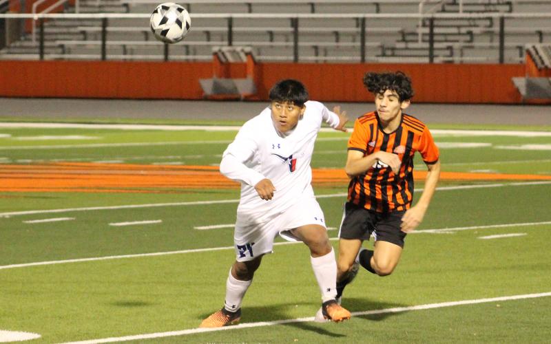 (TC GORDON | THE GRAHAM LEADER) Graham junior Donal Lopez (24) and a Springtown player both go for a ball during the Steers’ 2-1 victory Monday, Jan. 29 over the Porcupines.