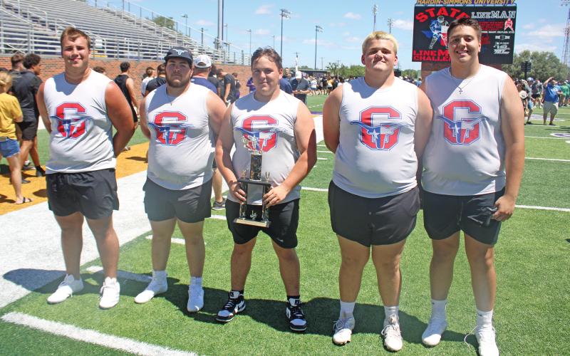 (ALEX HAVARDANSKY | THE GRAHAM LEADER) The Steers tug of war team with their championship trophy Saturday, June 21. After finishing the day in fourth for total competitions in the 4A district, it was nice to see the team end on a strong note, according to coach Lance Lefevre. 