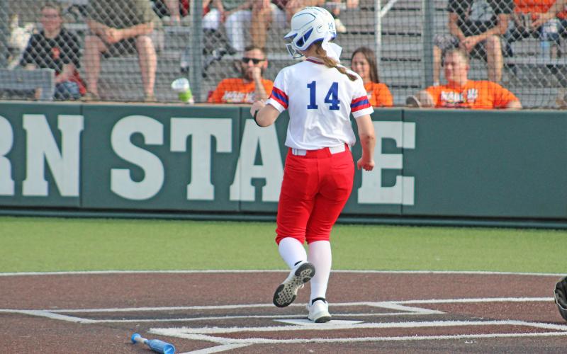 (TC GORDON | THE GRAHAM LEADER) Larissa Warren steps on home plate to score Graham’s first run of the game in the first of the best-of-three area round playoffs series against Burkburnett. The Lady Blues fought hard but lost the series two games to none to end their season.