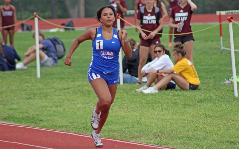 (TC GORDON | THE GRAHAM LEADER) Graham’s Camil Alejo pumps her arms as she heads for the finish line in the 200-meter Dash at the district track meet Monday, April 1 in Mineral Wells.