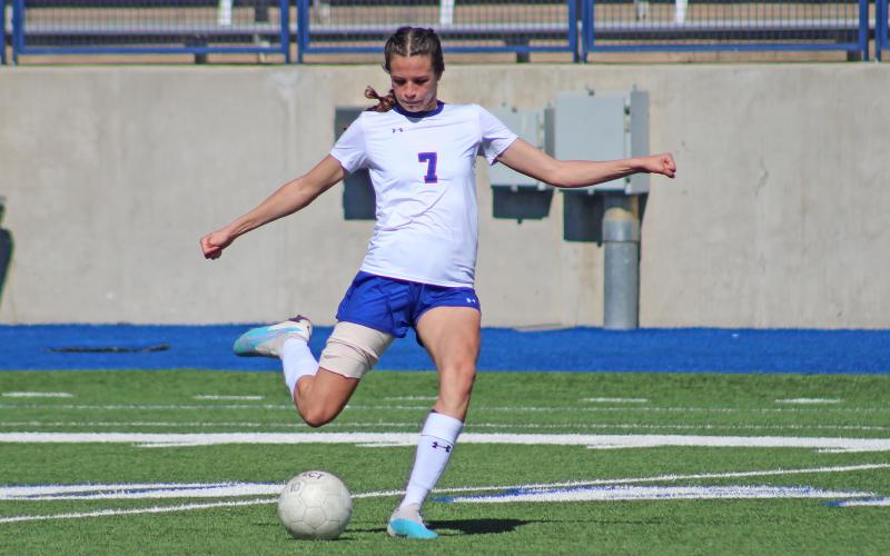 (TC GORDON | THE GRAHAM LEADER) Graham senior Sophie Schlieper loads up for a long free kick to her teammates trying to get in position to score during the team’s area round playoff game against San Elizario. The Lady Blues fought hard but took a 2-1 loss and saw their season come to a close.