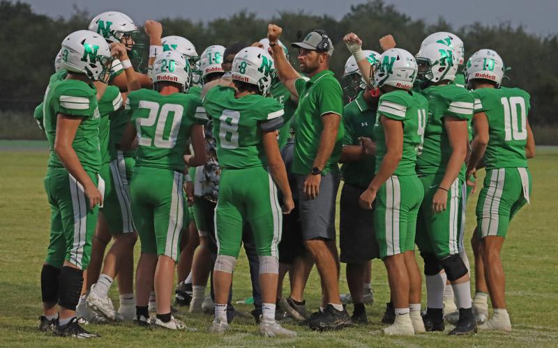 (THOMAS WALLNER | THE GRAHAM LEADER) The Newcastle Bobcats call for a team huddle before their game against the Crowell Wildcats. The Bobcats picked up their second straight blowout win over Crowell 73-0.