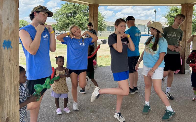 (KENZIE KLINE | CONTRIBUTED PHOTO) Several of the youth volunteers from Eastside Church of Christ lead dances, games, and balloon animal making with neighborhood children as a part of The Feet’s weekly Kids Club for kids of the area. Shown from left to right are Jack Caddell, Lexi Wolfe, Madi Wilde, Kenzie Kline, Jack Page and Emery Wilfong.