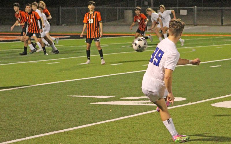 (TC GORDON | THE GRAHAM LEADER) Junior Easton Hedge (99) fires a free kick towards the goal as teammates and opponents follow the flight of the ball. Graham defeated Springtown on the road 2-1 Monday, Jan. 29.