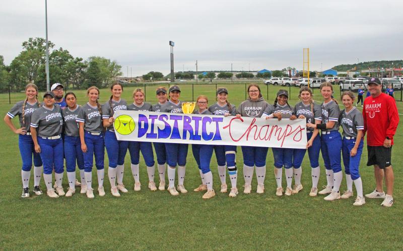 (TC GORDON | THE GRAHAM LEADER) The Lady Blues team and head coach Adam Arrington claimed the district championship for the second year in a row after they defeated Mineral Wells 13-7 in the regular season finale Friday, April 19.