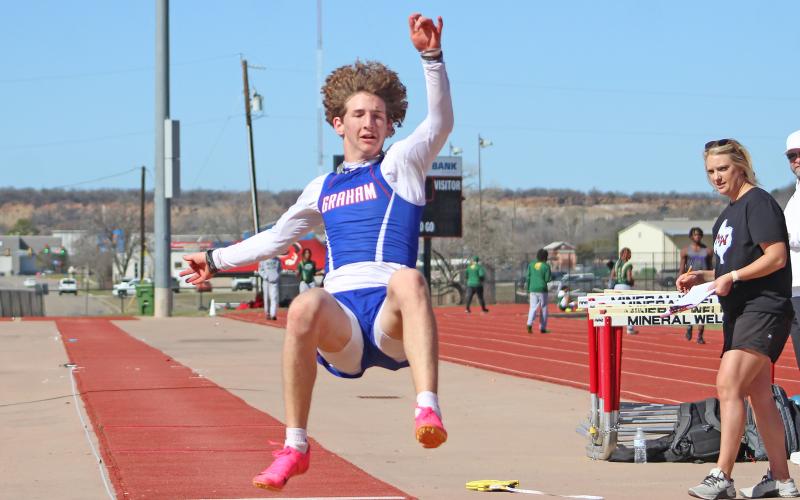 (TC GORDON | THE GRAHAM LEADER) Graham’s Peyton Kinman finishes one of his long jumps during the team’s first event of the season at the Ram Relays in Mineral Wells this past Saturday, Feb. 24.