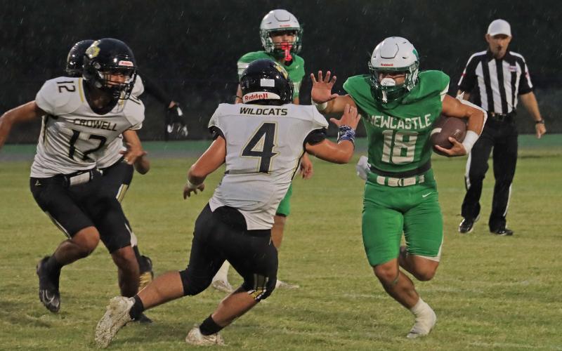 (THOMAS WALLNER | THE GRAHAM LEADER) Keyton Newland (18) puts a stiff arm on a runner while taking off with the football. The Bobcats defeated the Wildcats in their homecoming game Friday, Sept. 5.