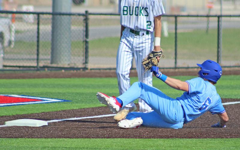 (TC GORDON | THE GRAHAM LEADER) Graham sophomore Tripp Mahaney slides into third base after hitting a triple during one of the team’s games as part of the Clyde tournament over the weekend.