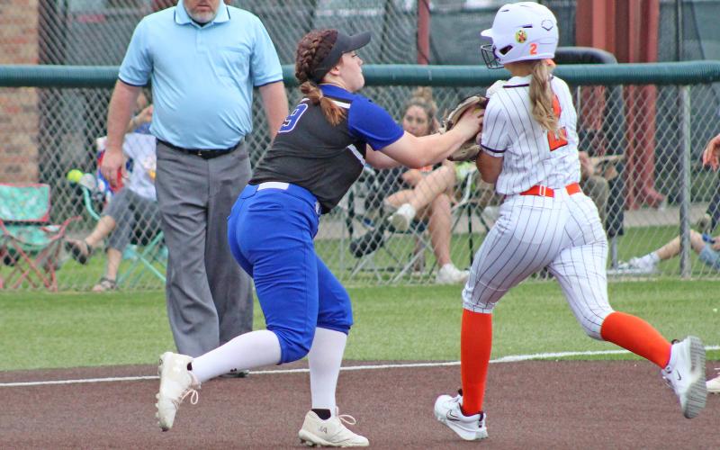 (TC GORDON | THE GRAHAM LEADER) Third baseman Emily Lawson fields a ground ball and tags out the lead Burkburnett runner for an out during the second game of the area playoffs series between the Lady Blues and Lady Bulldogs. Graham fought in both contests and kept each game close but ultimately lost the series to end the season.
